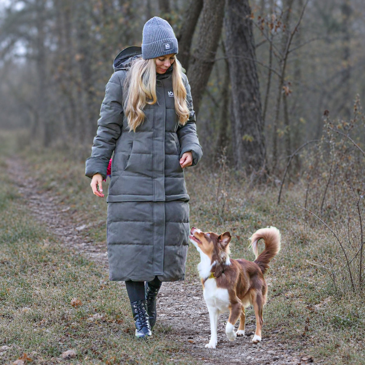 Frau im IQ Zip-off-Wintermantel beim Spaziergang mit ihrem Hund